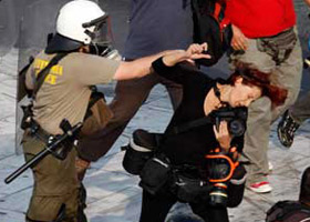 Photographer Pounched by a Police Officer